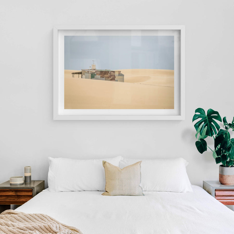 Buried at Tin City, a Tin City shack, recessed in rolling dunes of sand.