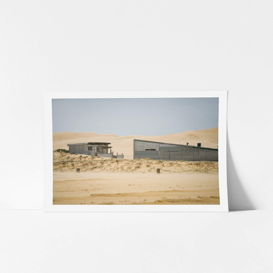 From The Beach at Tin City, two corrugated iron structures sit low against the dunes at Tin City, Stockton Beach.