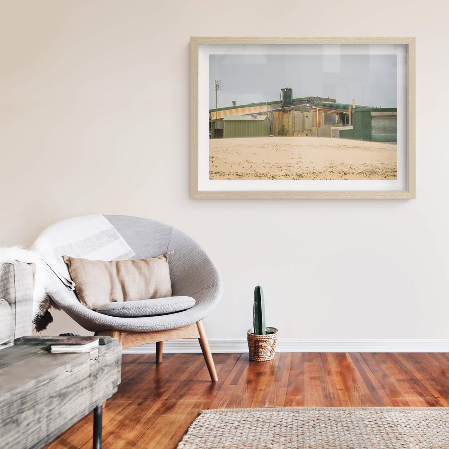 Patchwork at Tin City, green and rust-brown corrugated iron panels sit side by side across a long, low structure.
