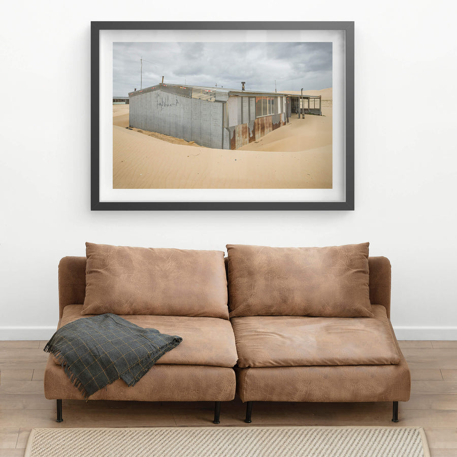 Recess at Tin City, sand banks hard against corrugated iron walls, rising halfway up the structure.