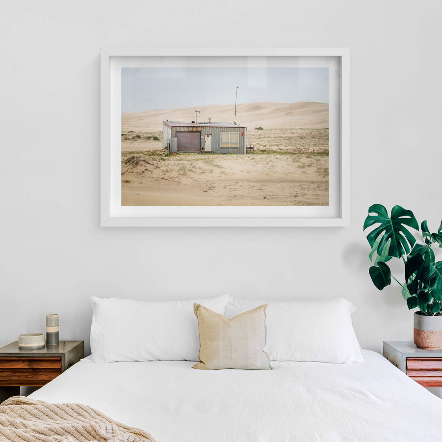 Seven Seven South West at Tin City, shack number seven sits alone against a wall of sand dunes that rises behind it like.