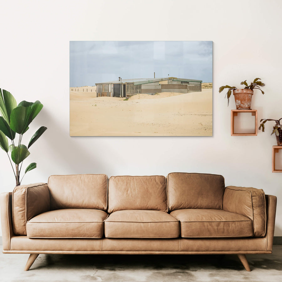 The Workshop at Tin City, a low corrugated iron structure sits half-swallowed by sand dunes at Tin City.