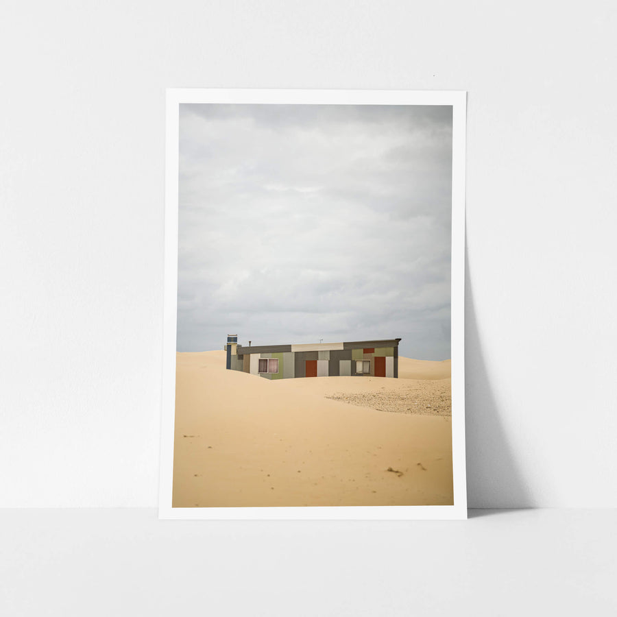 Waves at Tin City, a corrugated iron shack sits half-swallowed by sand dunes at Tin City.