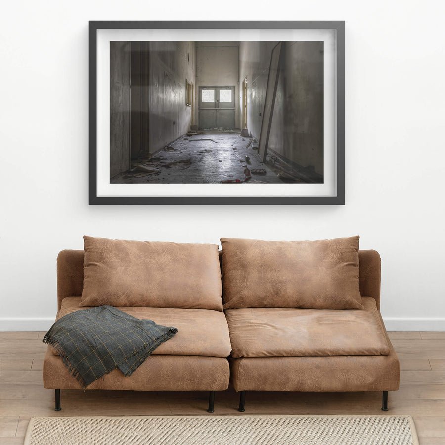 Hallway at Wangi Power Station, a narrow corridor runs toward a pair of steel double doors.