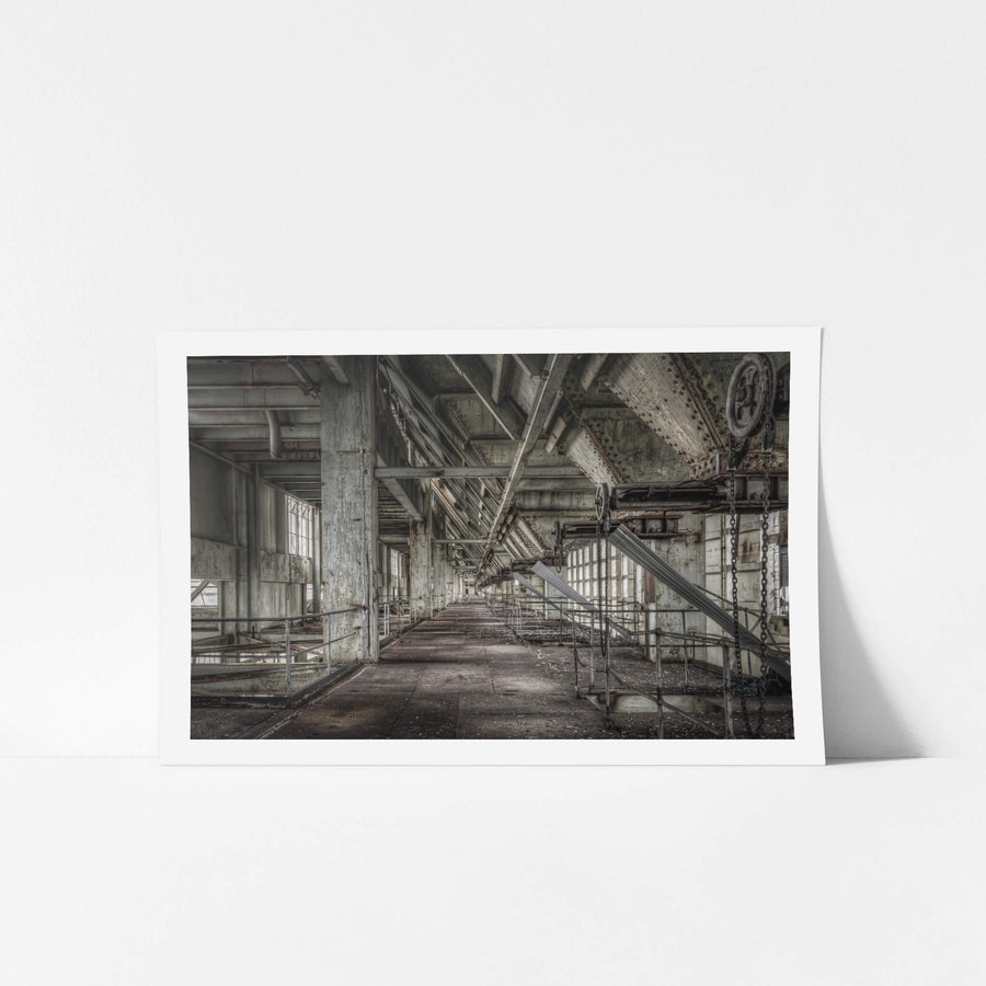 Weigher Floor at Wangi Power Station, a long concrete corridor stretches deep into the building, flanked by steel railings.