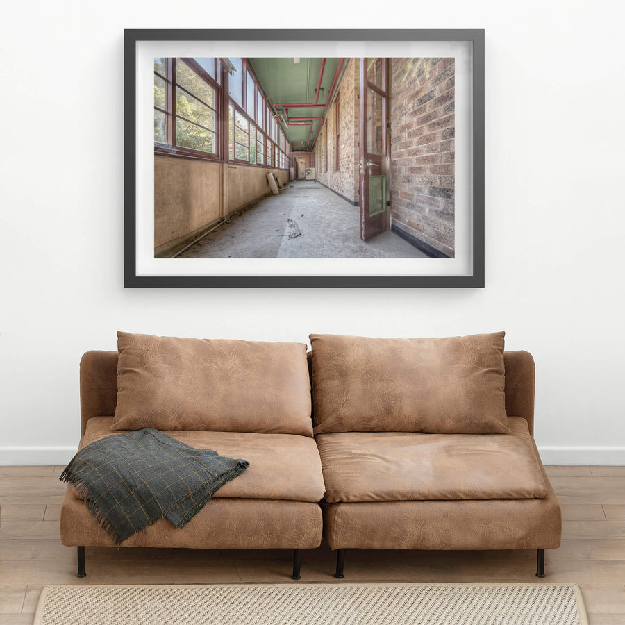 Annex at Waterfall Sanatorium, a long enclosed corridor runs between a brick ward building and a wall of timber-framed.