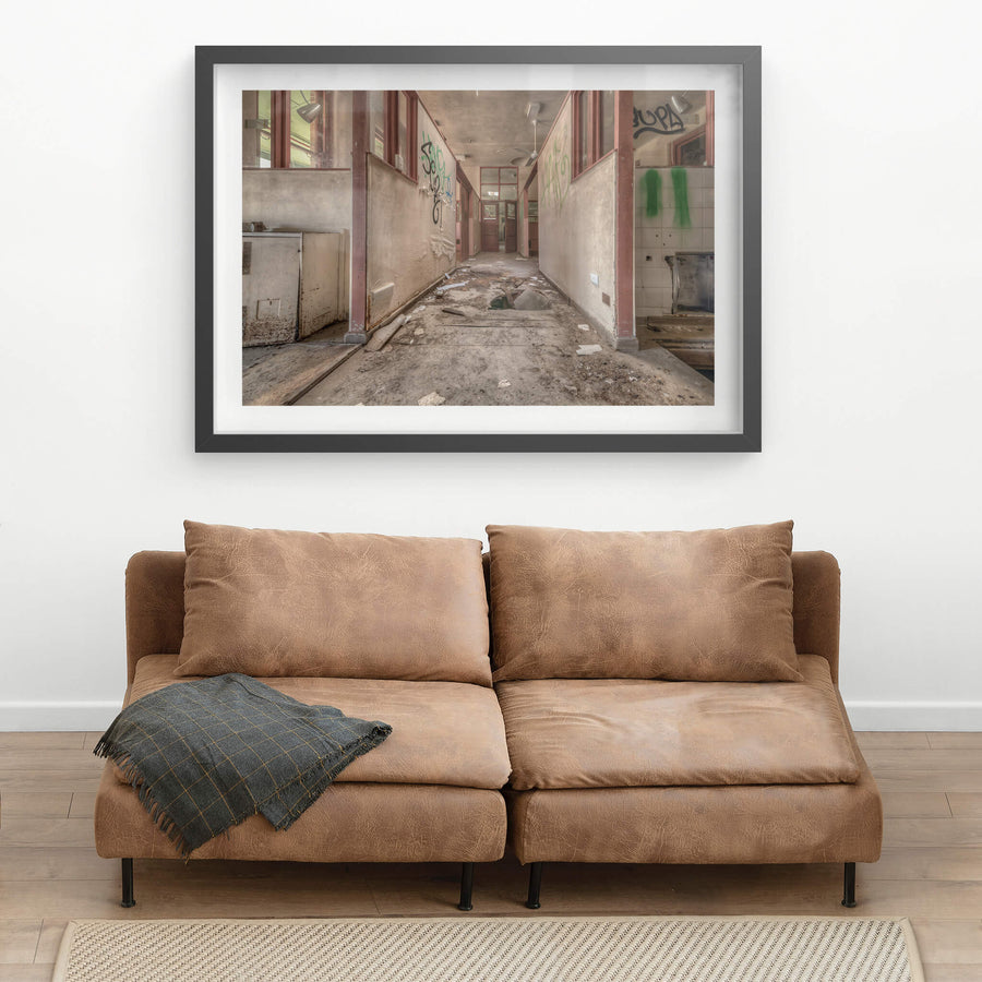 Fallen Through at Waterfall Sanatorium, a corridor runs between partitioned rooms, their maroon-trimmed frames holding.