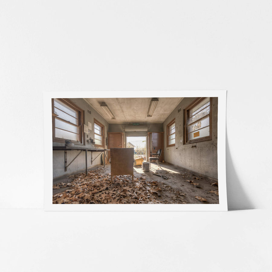 Fallen at Waterfall Sanatorium, dead leaves surrounding a chair in a small utility room.