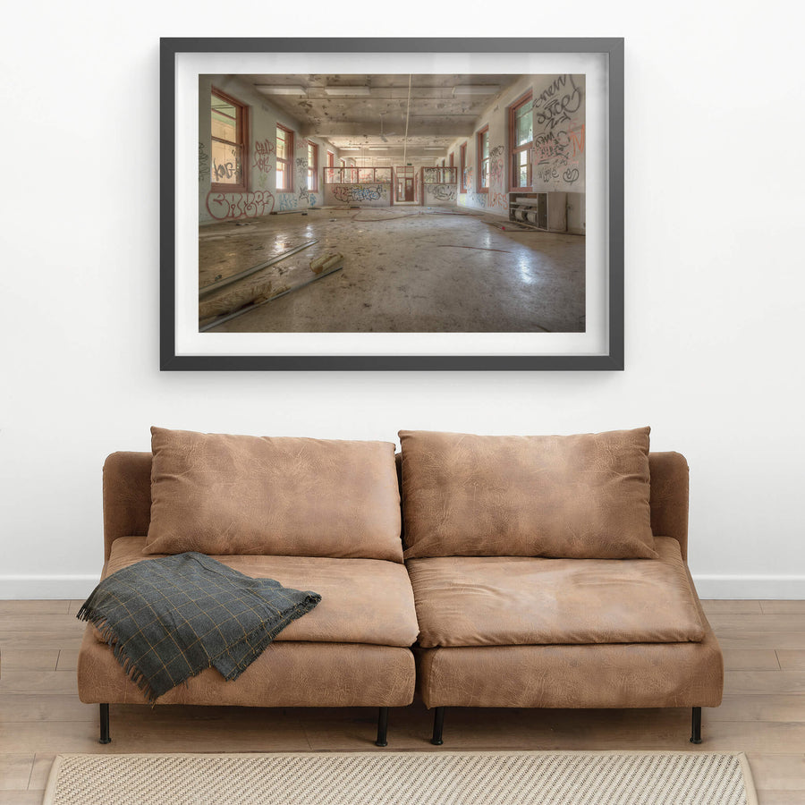 Looking Down The Ward at Waterfall Sanatorium, a long open room stretches back toward a partitioned doorway.