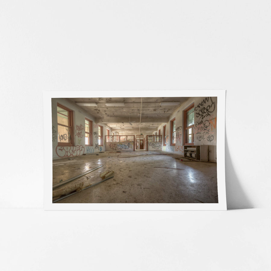 Looking Down The Ward at Waterfall Sanatorium, a long open room stretches back toward a partitioned doorway.