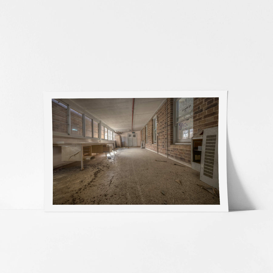 Marbled Lino at Waterfall Sanatorium, a long corridor runs between a brick interior wall and a row of louvred windows.