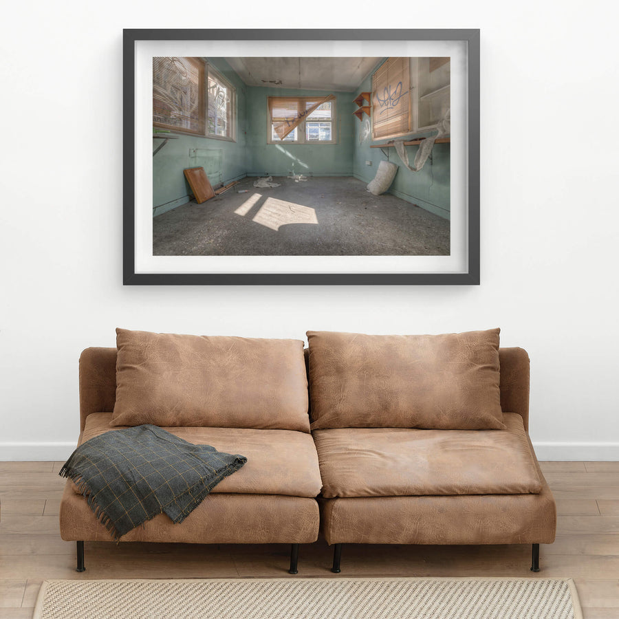 Peeking Through The Blinds at Waterfall Sanatorium, pale green walls hold three windows.