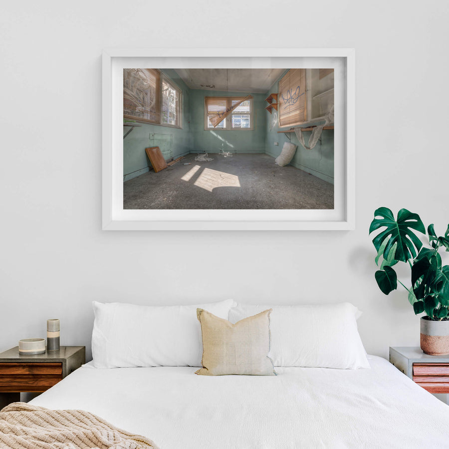 Peeking Through The Blinds at Waterfall Sanatorium, pale green walls hold three windows.