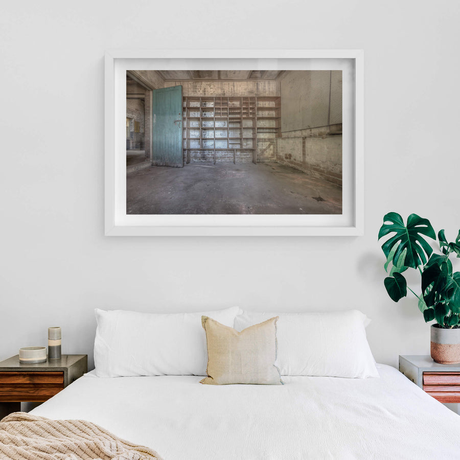 Storage Shelves at Waterfall Sanatorium, a timber shelving unit covers the back wall, its grid of open compartments.