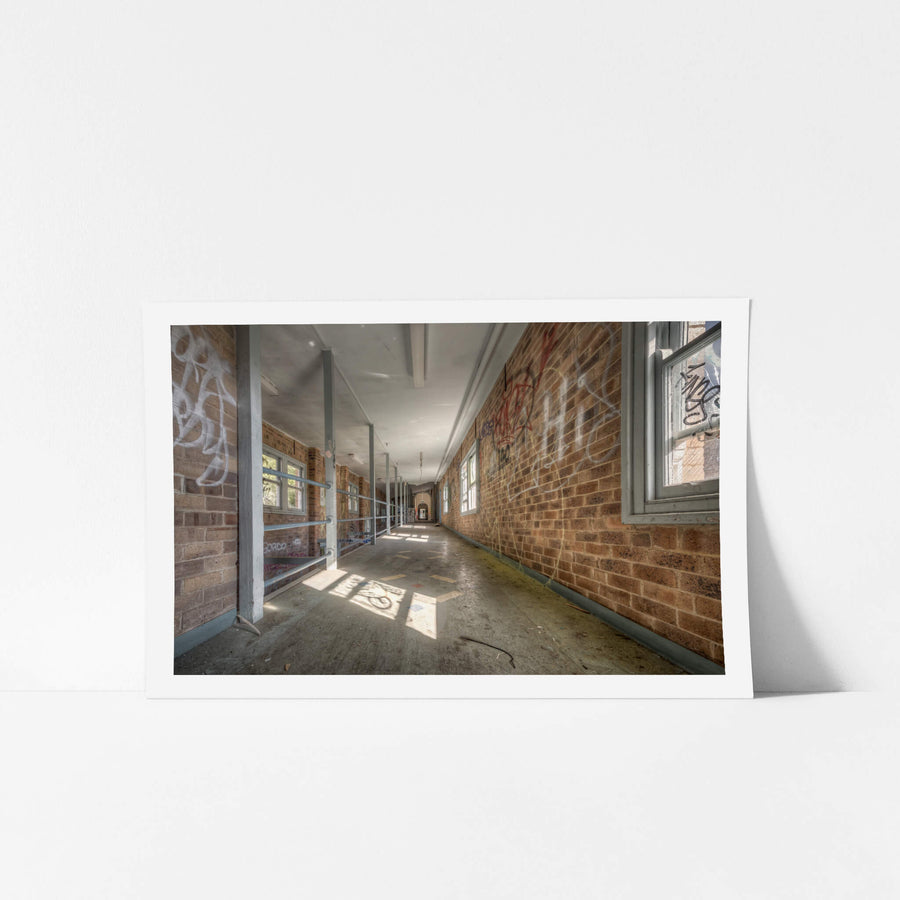 Switchback at Waterfall Sanatorium, a long corridor stretches deep into the building, flanked by brown brick walls thick.
