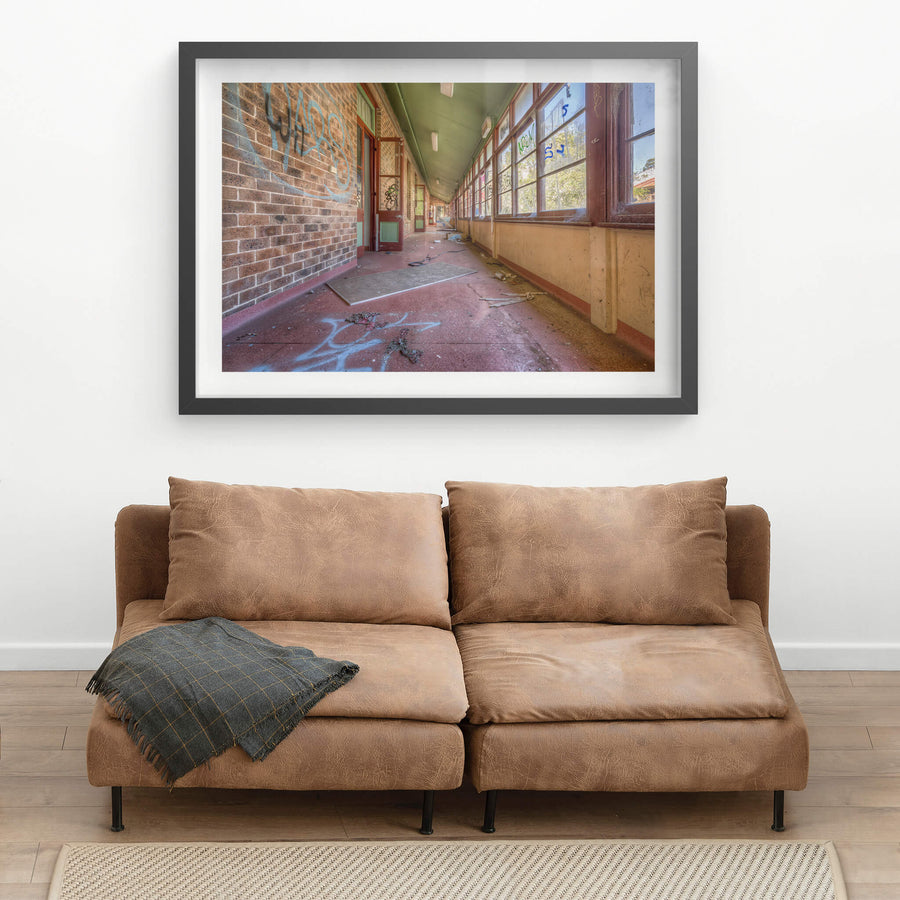 The Long Walk at Waterfall Sanatorium, a covered verandah runs deep into the building, narrowing to a vanishing point.