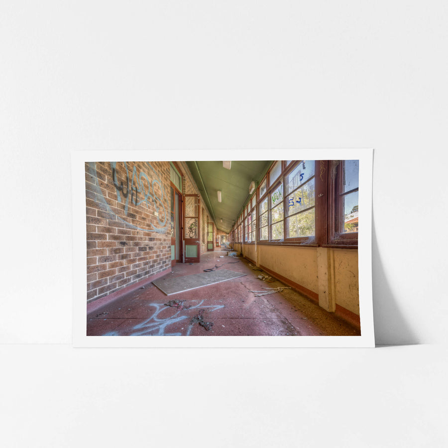 The Long Walk at Waterfall Sanatorium, a covered verandah runs deep into the building, narrowing to a vanishing point.