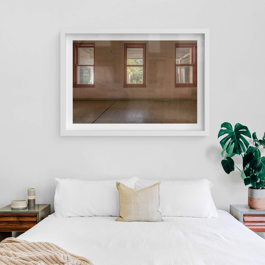 Three Windows at Waterfall Sanatorium, three timber-framed windows sit evenly spaced across a rendered wall.