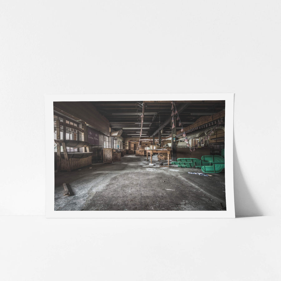 Souvineer Shop at Western Village, american flags hang limp from timber beams above a wide concrete floor.