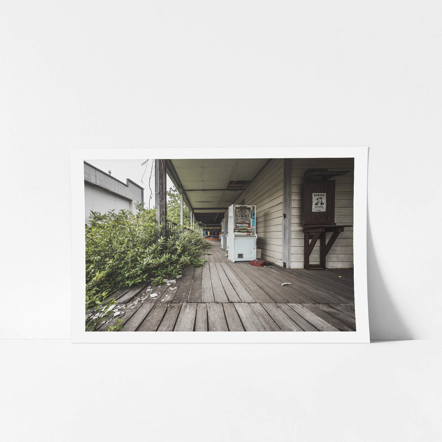 Verandah at Western Village, a weathered timber verandah runs along a western-style clapboard building.