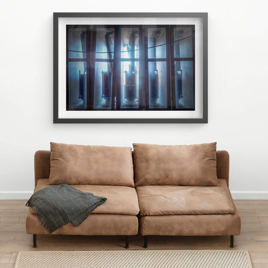 Backlit Reactors at White Bay Power Station, high-voltage reactor switches stand in glass-panelled enclosures, backlit.