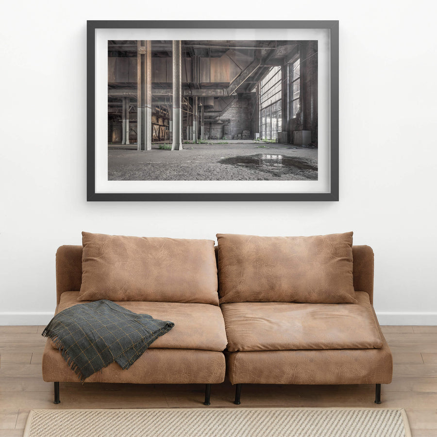 Boiler House Basement at White Bay Power Station, steel columns rise from a concrete floor slick with standing water.