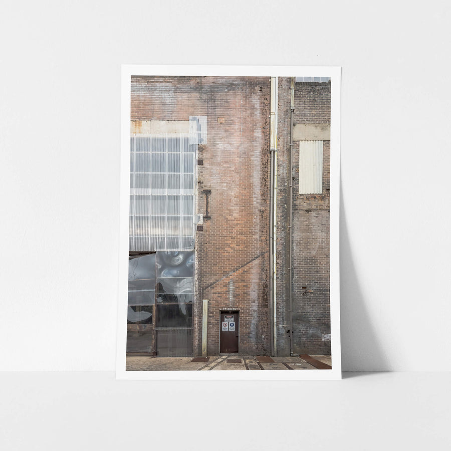 Boiler House Exterior at White Bay Power Station, a solitary door, dwarfed by the towering red brick wall of the Boiler.