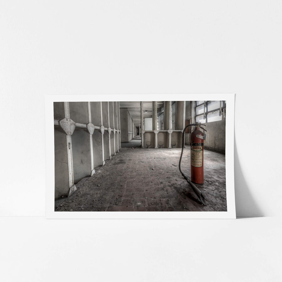 Fire Extinguisher at White Bay Power Station, a red Quell fire extinguisher stands on a grime-covered brick floor.