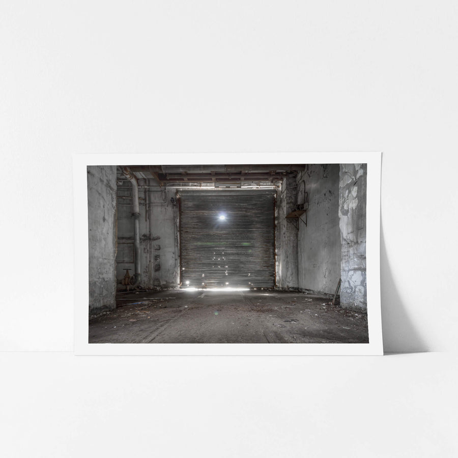 Roller Door at White Bay Power Station, a steel roller door fills the frame, sealed shut between concrete walls.