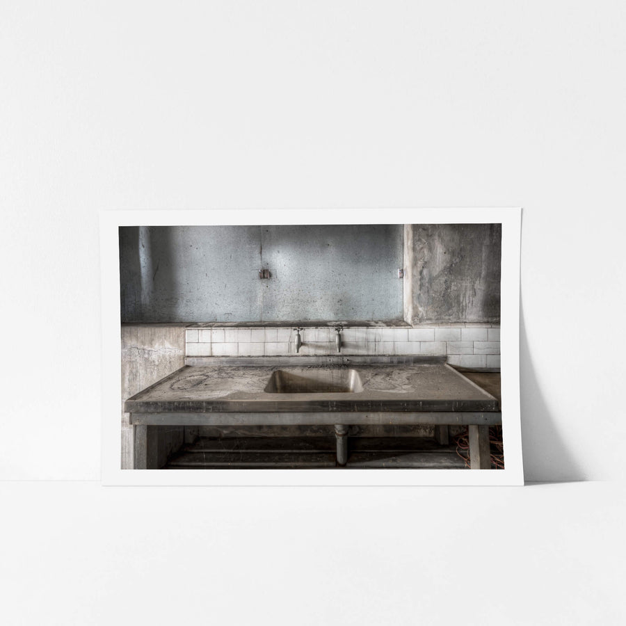 Sink at White Bay Power Station, a stainless steel sink sits square in the frame, its draining boards thick with grey dust.