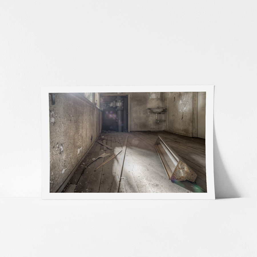 Turbine Hall Crib Room at White Bay Power Station, a fluorescent light fixture lies face-down on bare timber floorboards.